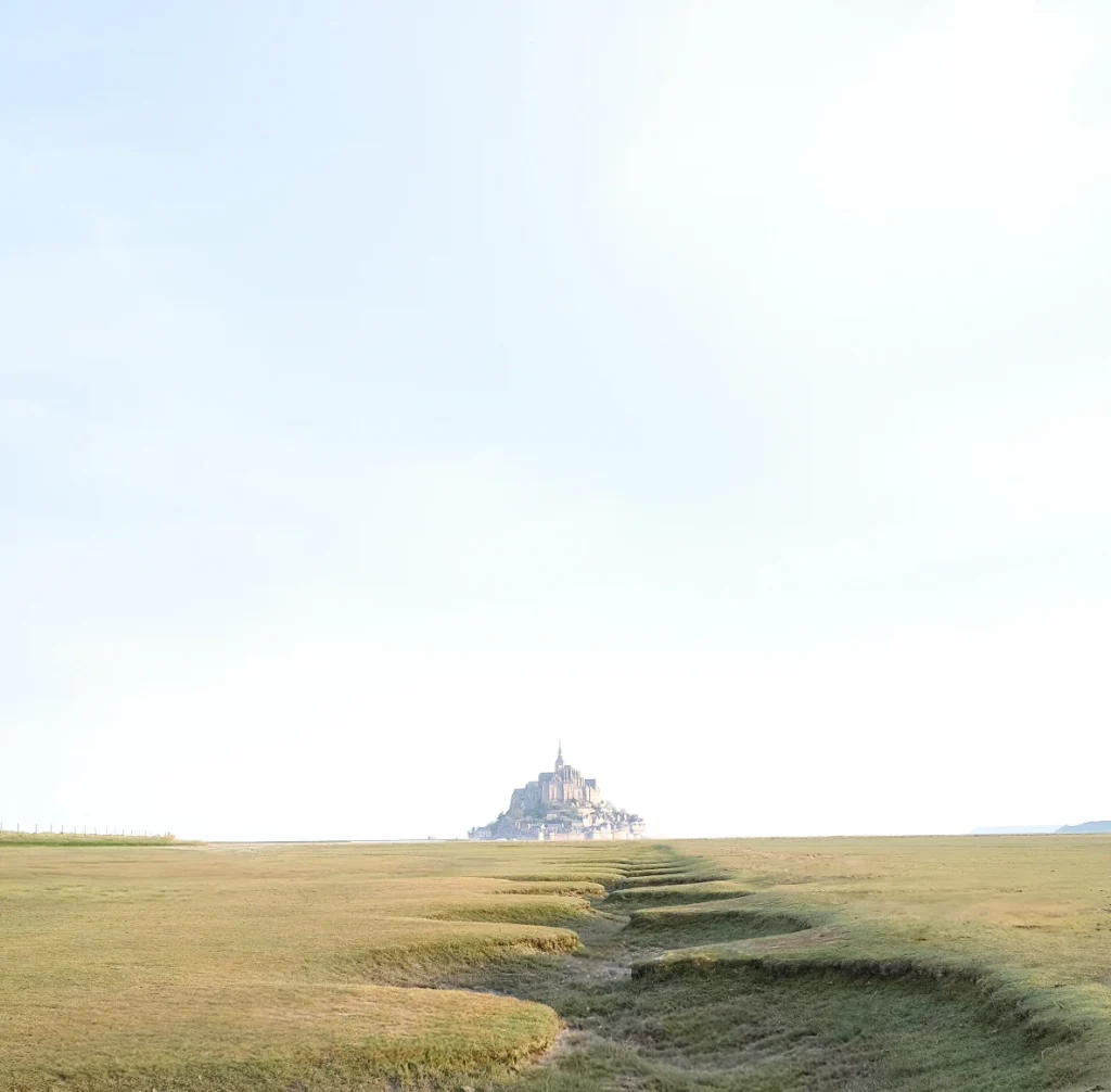 Distant view of Mont-Saint-Michel – scenic French coast print, travel wall photography.