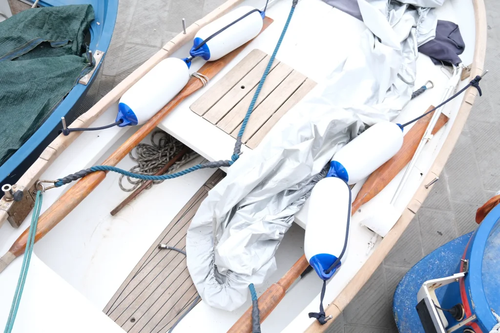 Close-up of moored boats with ropes and bumpers in Italy.