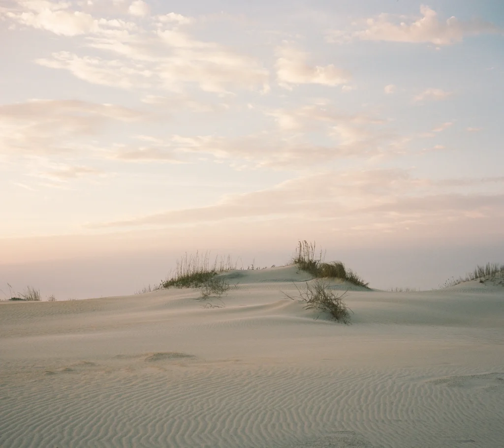 Soft pink clouds over a beach dune – dreamy seascape wall print, Europe nature photography.