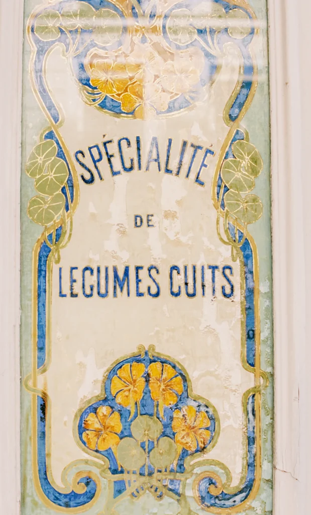 Vintage French tile reading "Spécialité de Légumes Cuits."