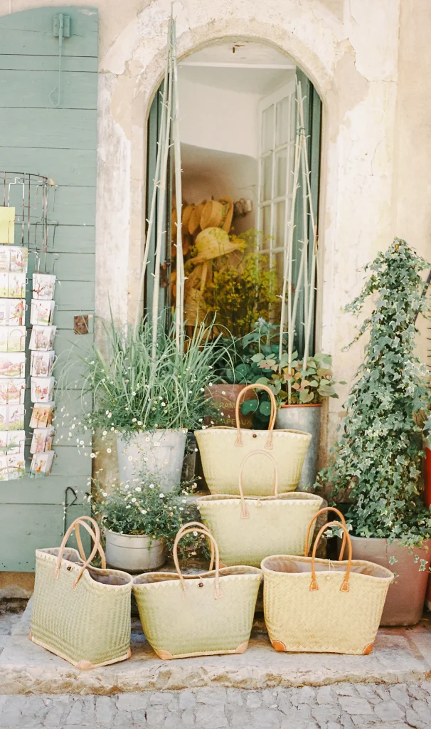 French storefront with baskets and herbs – rustic Provence travel print, charming wall decor.