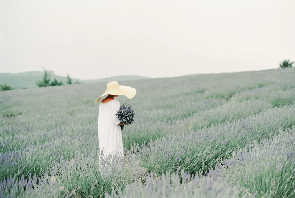 Woman in white dress holding lavender – dreamy France travel print, romantic wall art.
