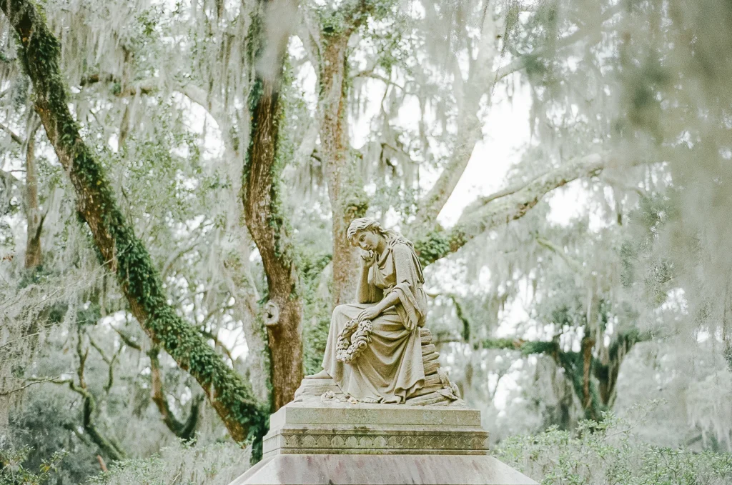 Stone statue in wooded park – historic sculpture travel print, elegant wall decor.