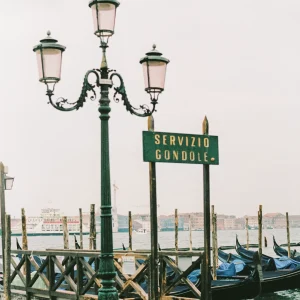 Vintage-style streetlamp near gondola service dock in Venice.