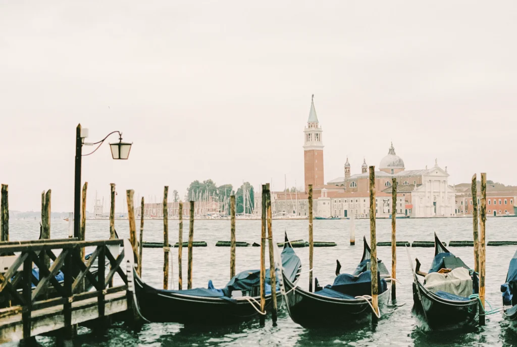 Traditional gondolas docked with San Giorgio Maggiore in the background.